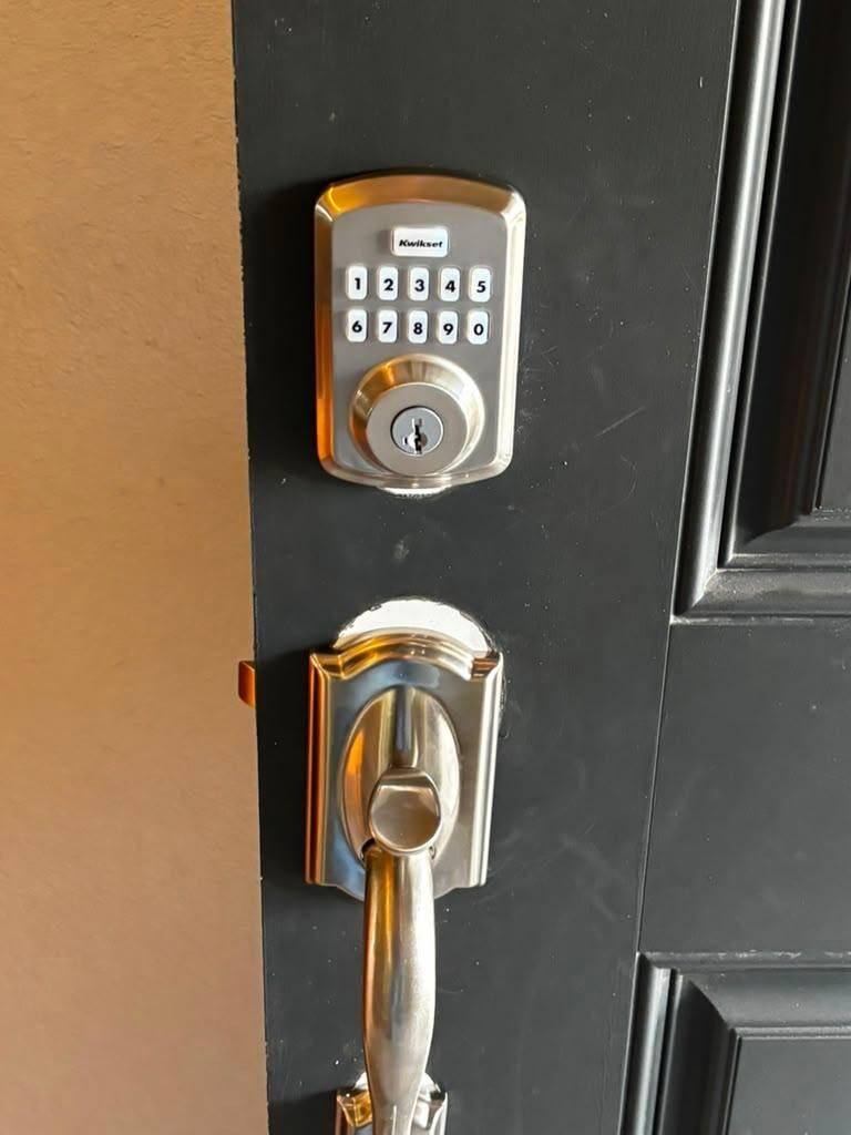 Kwikset keypad deadbolt installed on residential door.